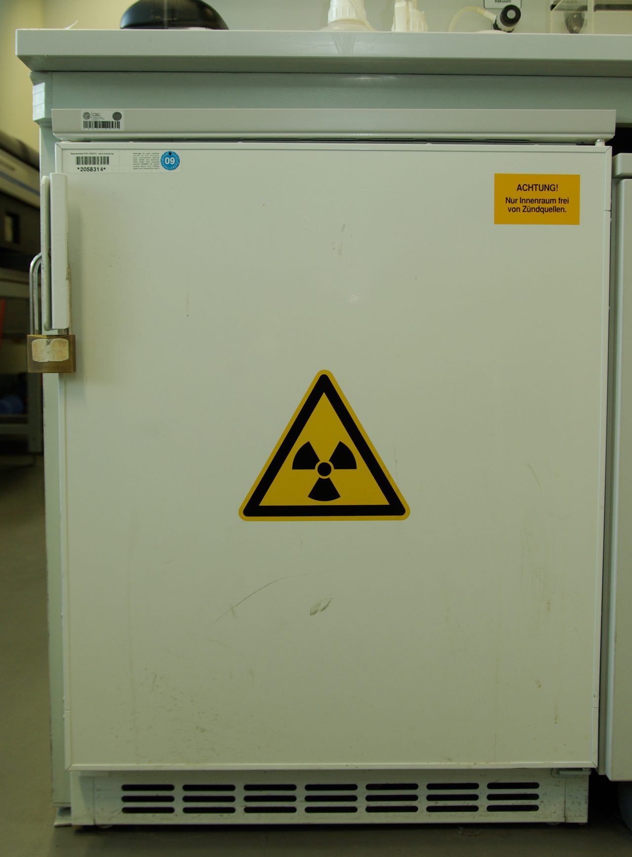 Laboratory / medical refrigerator with solid white PU-foam-insulated door (closed, with safety lock) in a research lab — typical solid-door application for medical / pharmaceutical / vaccine / radioisotope cold storage OEM